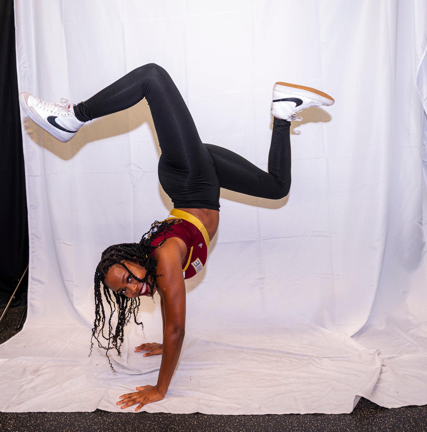 A member of the cheer team performs a handstand