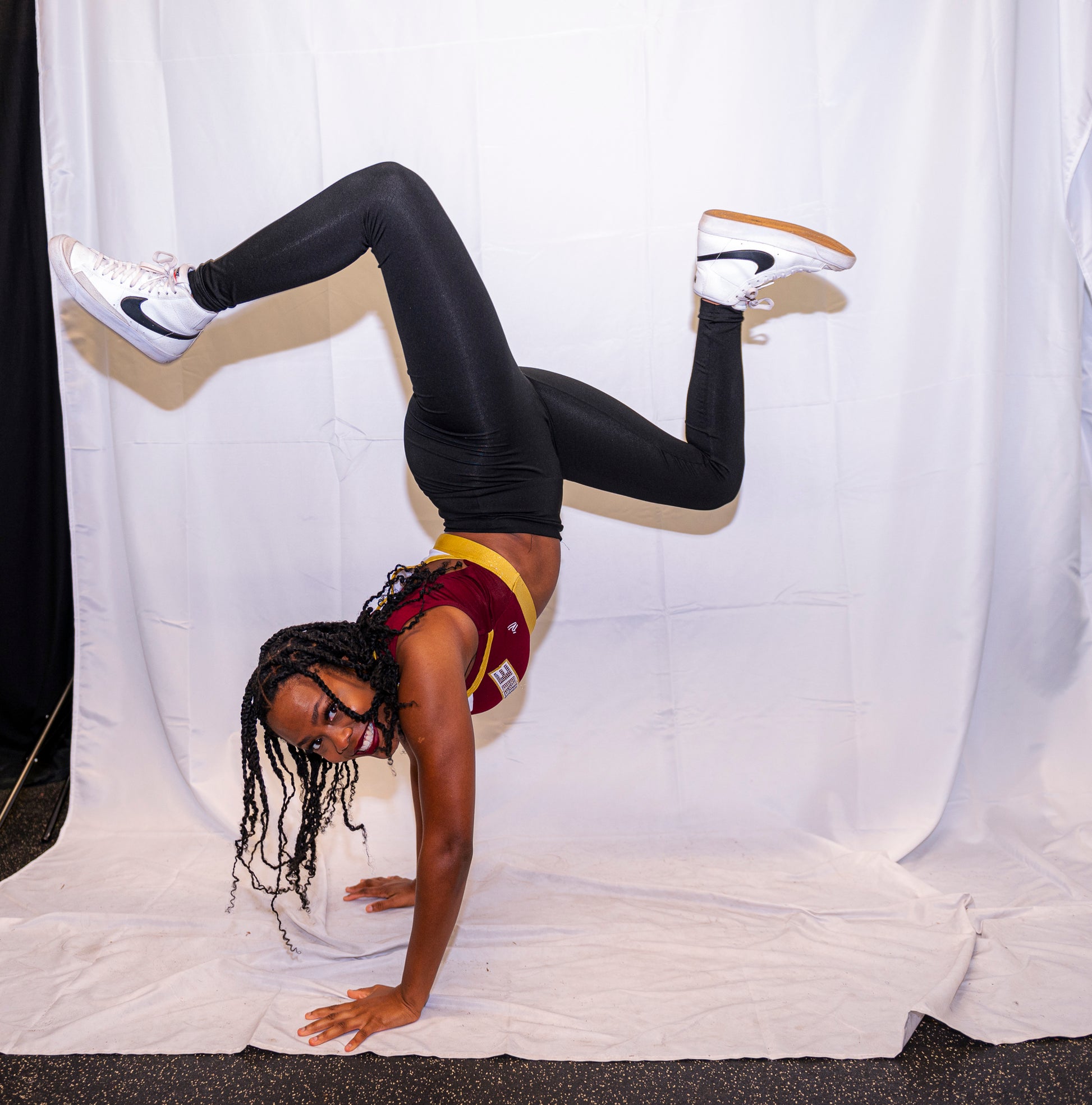 A member of the cheer team performs a handstand
