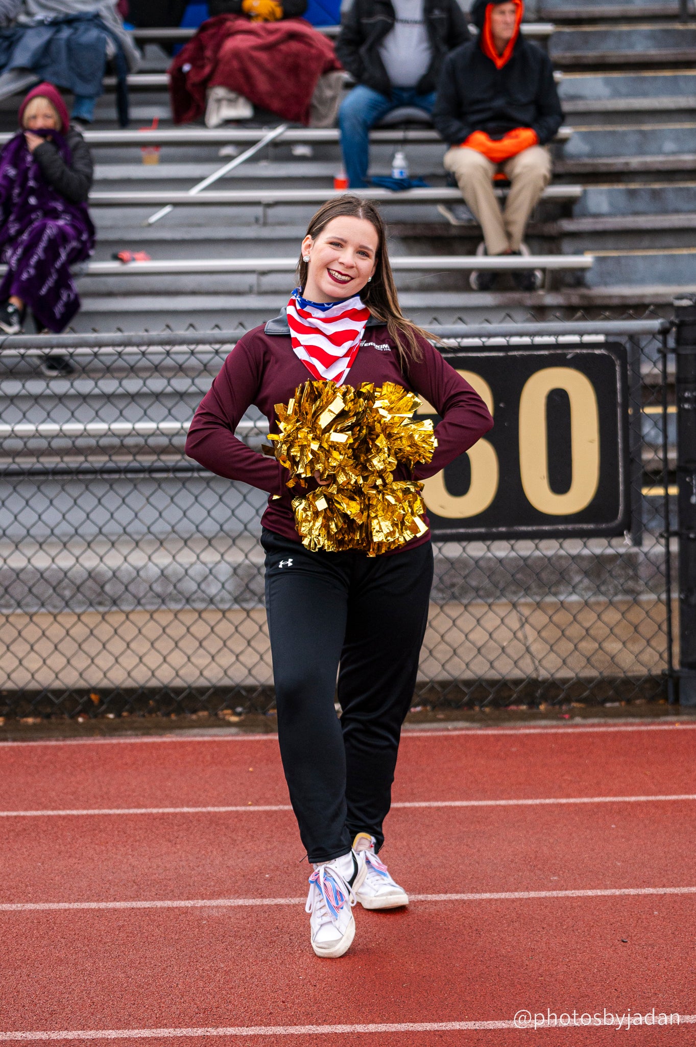 Erskine cheerleader poses with gold pompoms