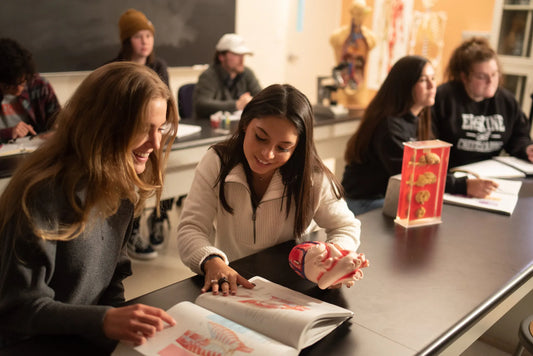 Two Erskine students read a textbook in the biology lab