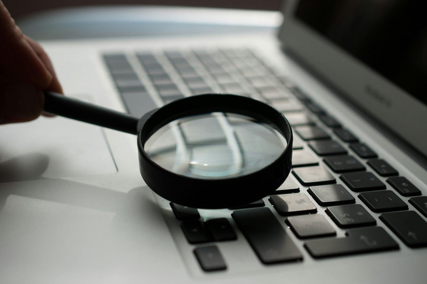 A microscope over a laptop computer