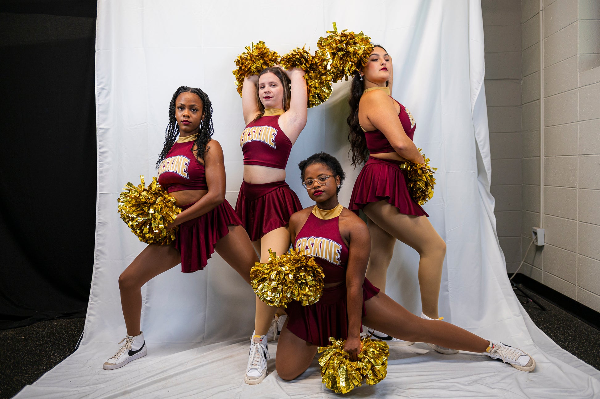Fleet cheerleaders pose together with pompoms