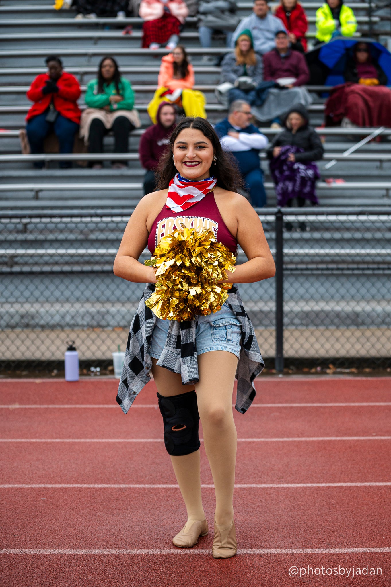 Cheerleader poses at a football game