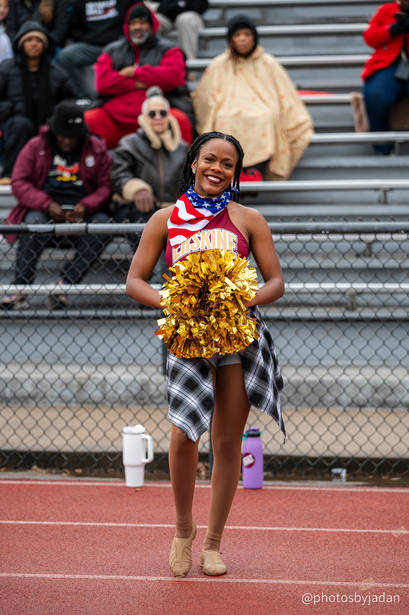 Cheerleader poses in front of the stands